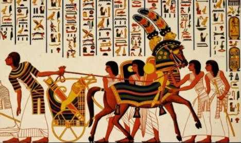 Several men restrain an energetic horse with chariot.