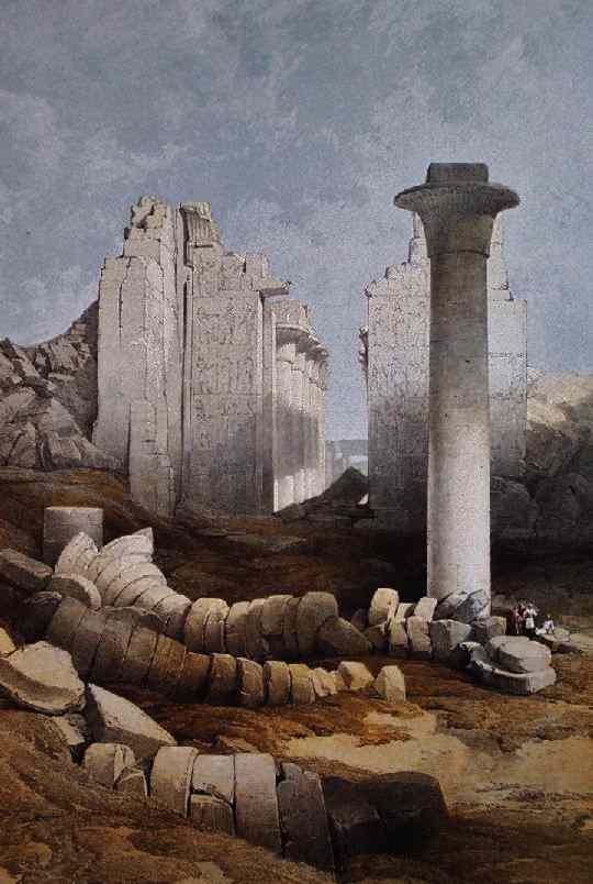 A small group of men is almost lost in a field of overturned columns.