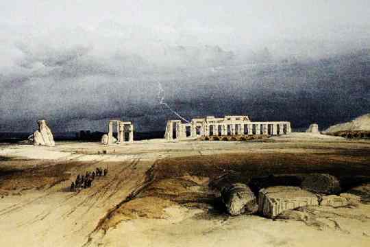 The approach to the temple, a long line of columns in the desert.